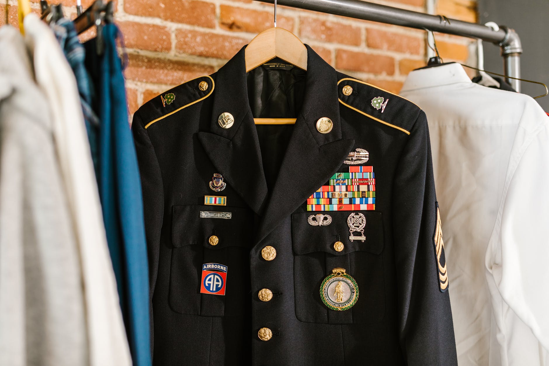 photo of military uniform hanging on a rack