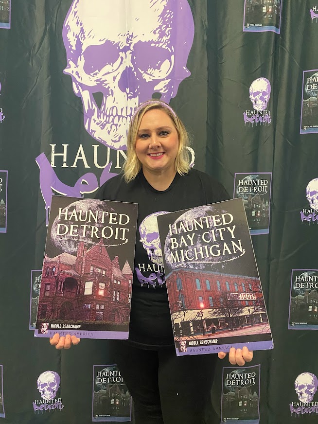 Author displaying book covers