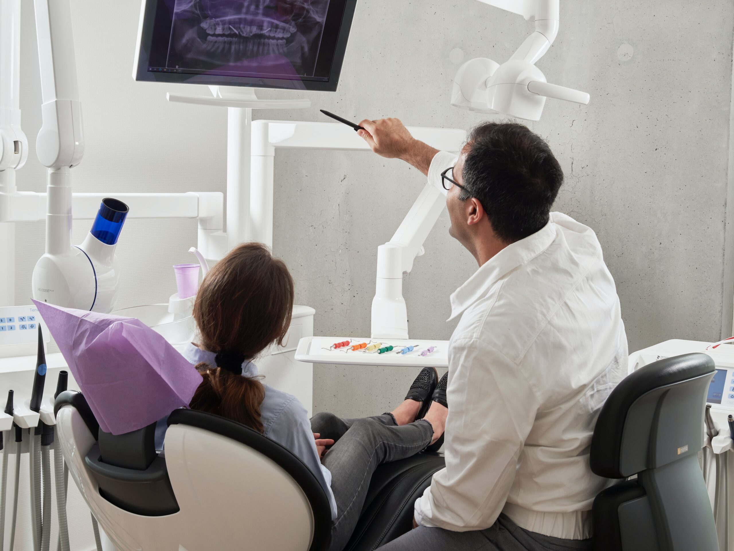 Dentist showing a patient an x-ray of their teeth