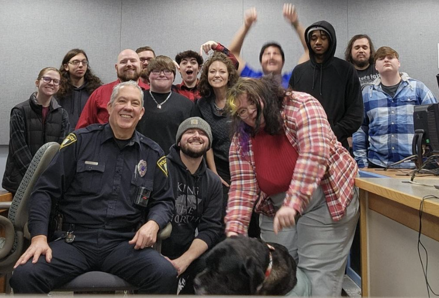 Officer Rupp poses for a picture with Kimberly Wells’ studio production class and Sofia Burdo's dog.