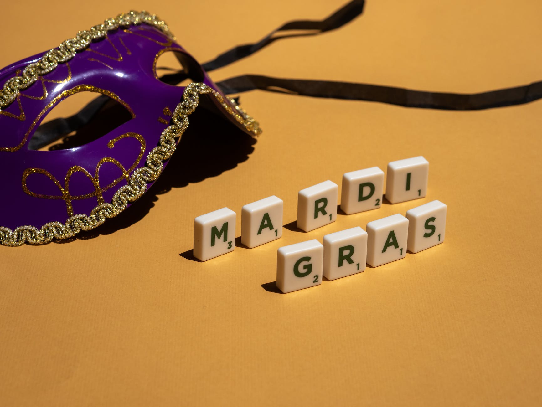 letter blocks forming mardi gras and masquerade mask