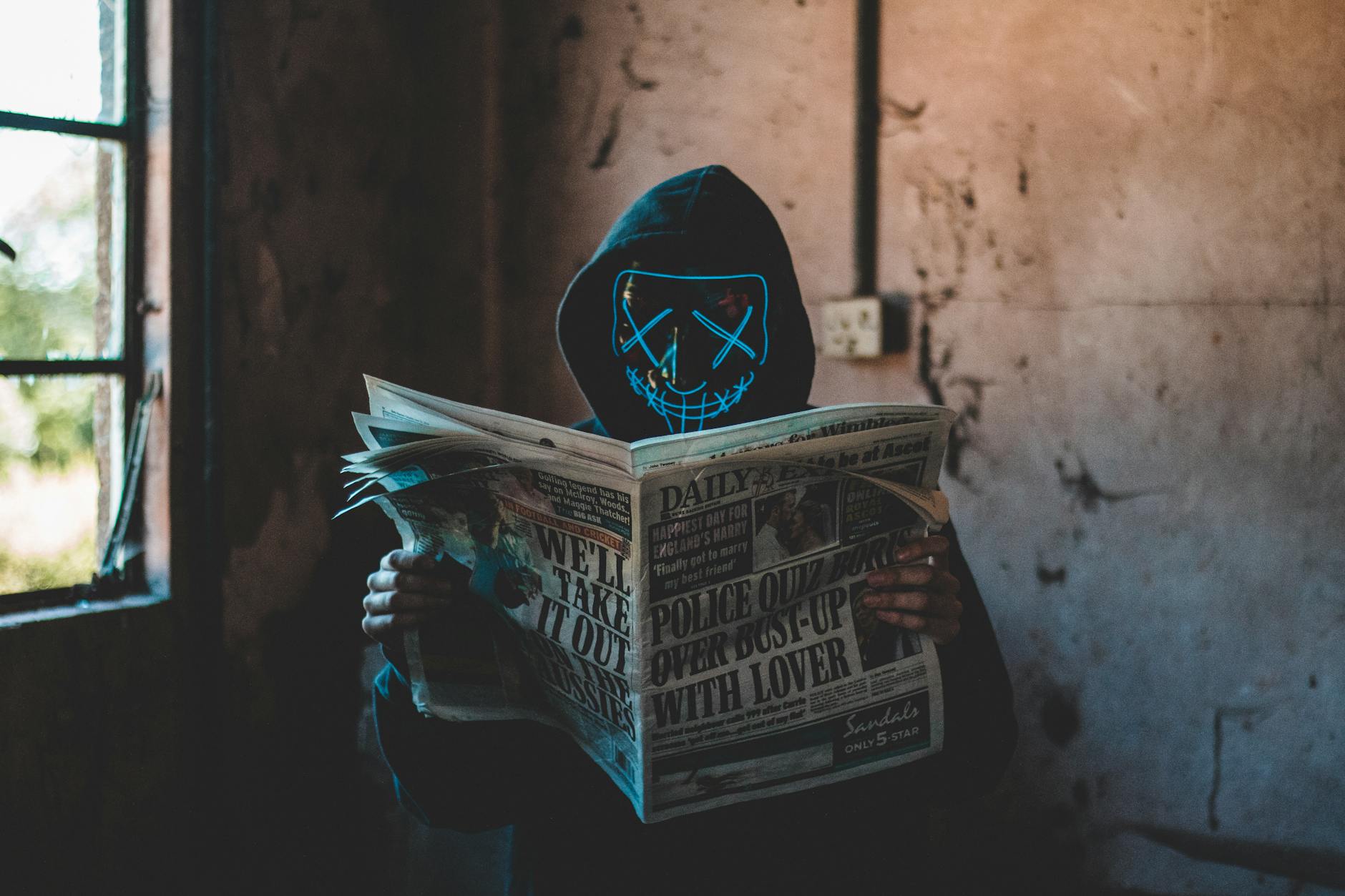 person reading newspaper inside room