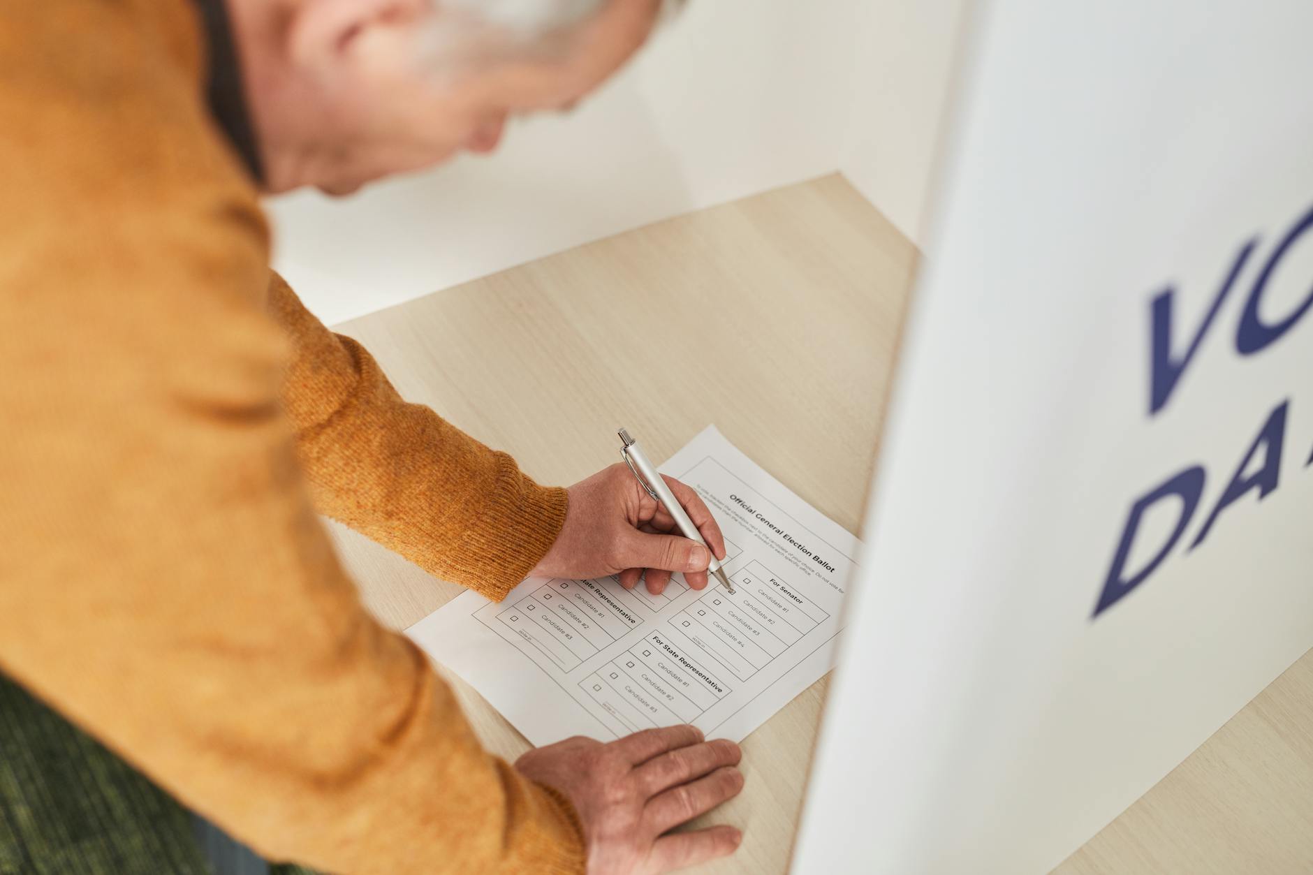 a man writing on a white paper